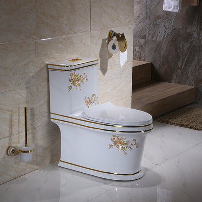 WC monoblocco a filo e chiusura ammortizzata in ceramica dorata